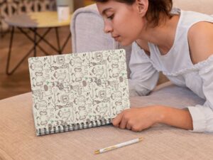 spiral-notebook-mockup-featuring-a-woman-reading-29955