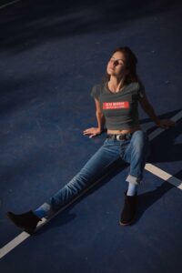 crop-top-mockup-of-a-woman-wearing-a-t-shirt-lying-on-a-tennis-court-at-night-19327