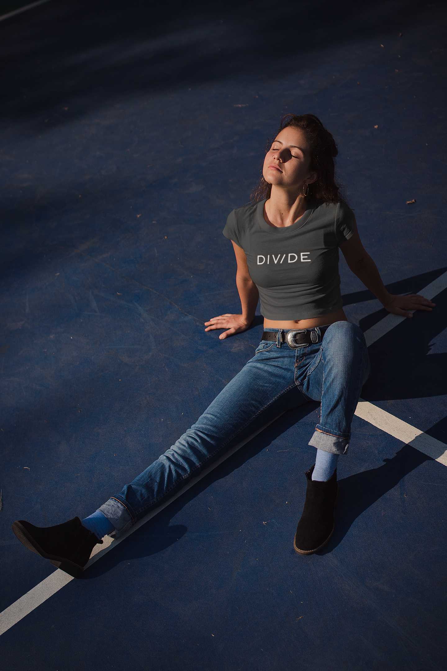 crop-top-mockup-of-a-woman-wearing-a-t-shirt-lying-on-a-tennis-court-at-night-19327