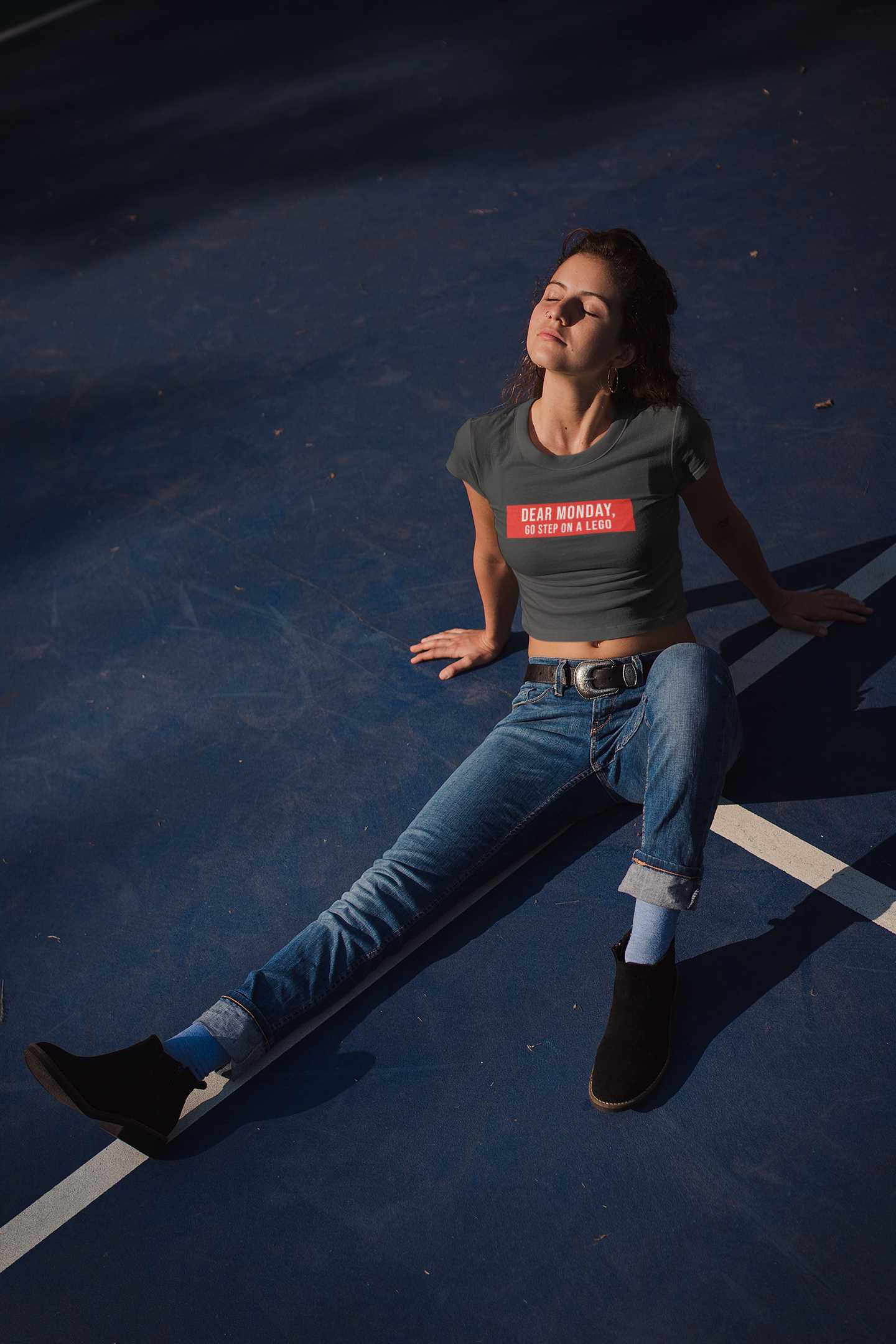 crop-top-mockup-of-a-woman-wearing-a-t-shirt-lying-on-a-tennis-court-at-night-19327