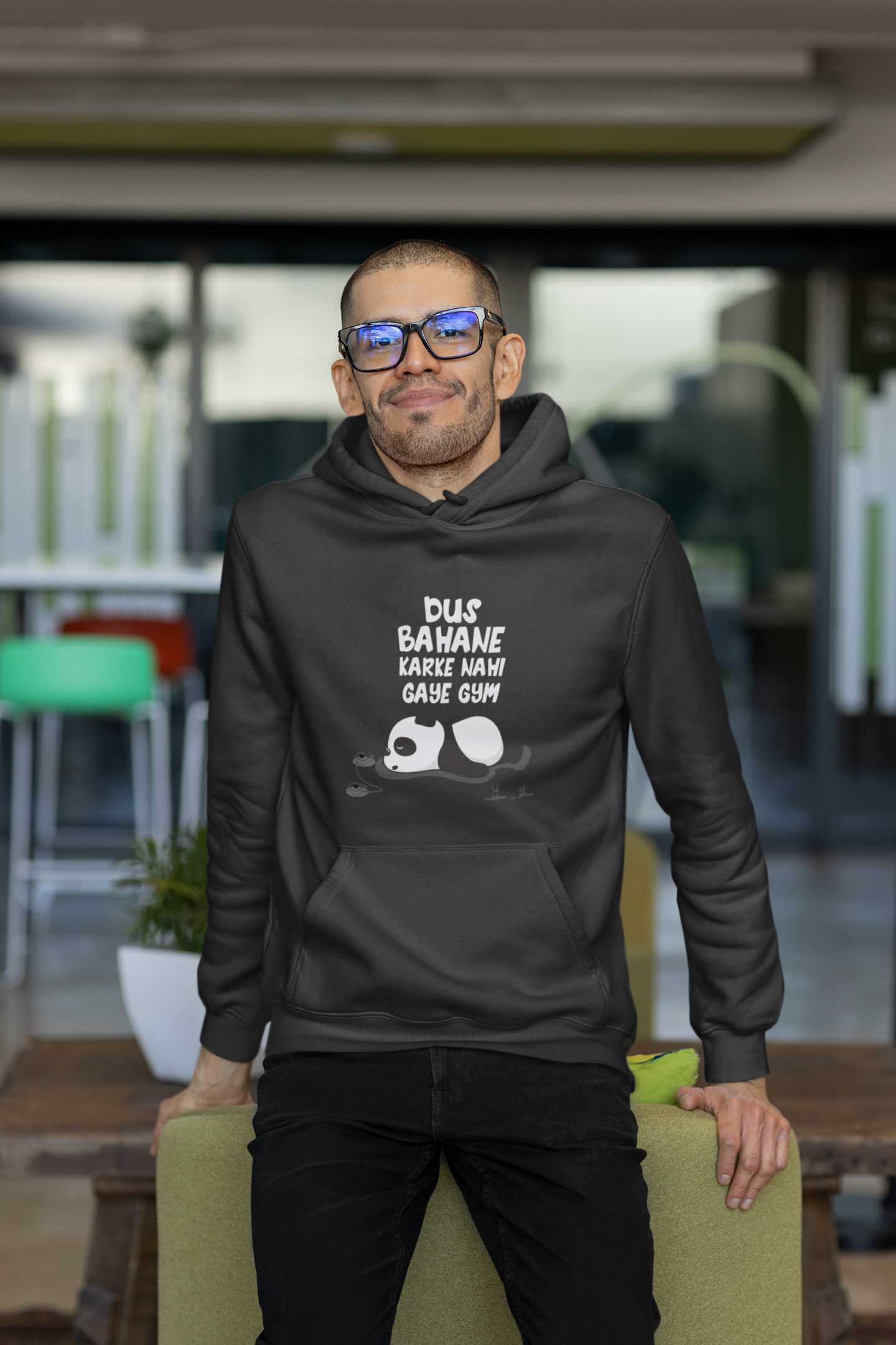 hoodie-mockup-of-a-man-with-glasses-leaning-on-a-couch-m24806