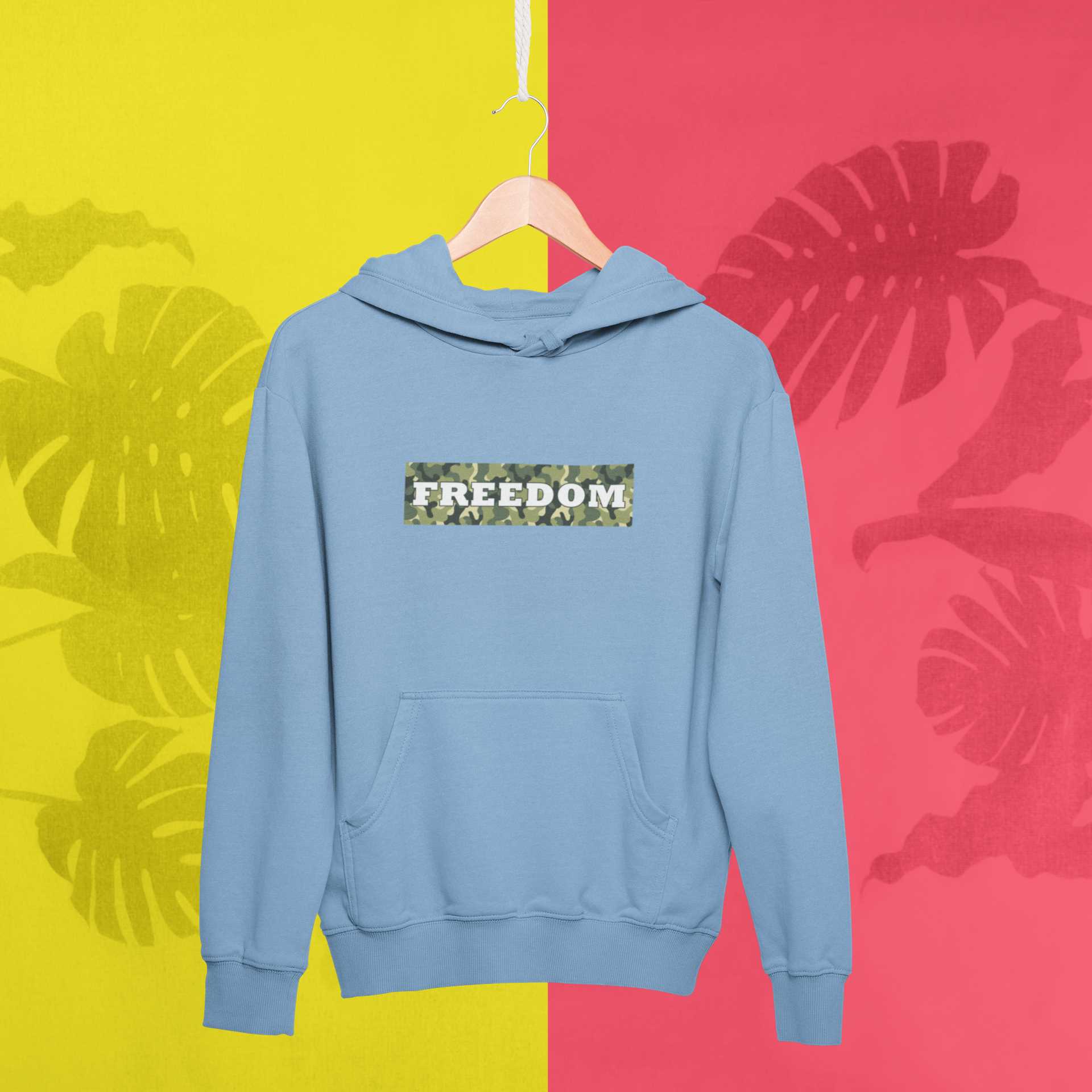 mockup-of-a-hanger-with-a-pullover-hoodie-against-a-tropical-surface-27019
