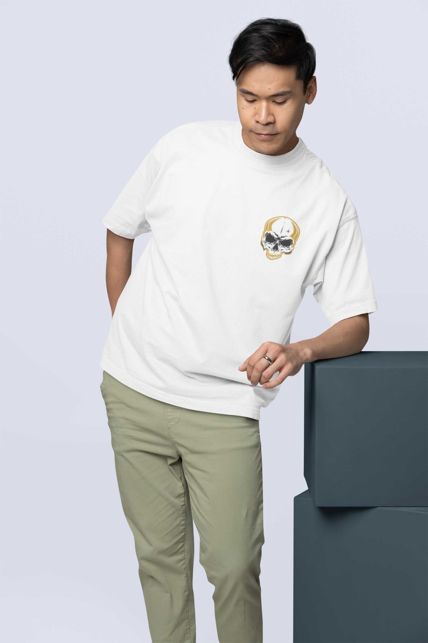 oversized-t-shirt-mockup-featuring-a-man-leaning-on-a-colorful-cube-m38921