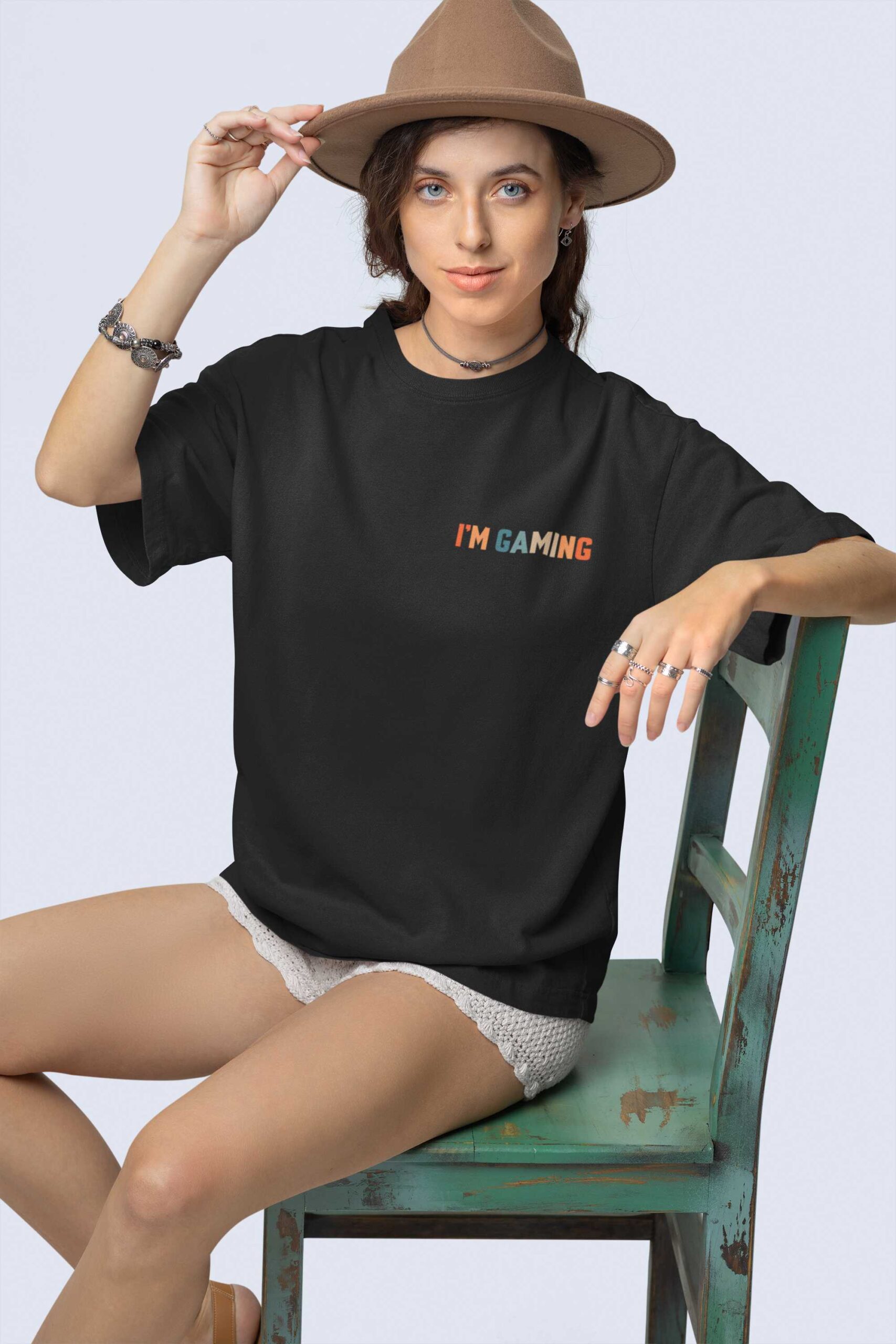 stanley-stella-t-shirt-mockup-featuring-a-woman-with-a-boho-styled-look-sitting-on-an-old-chair-m36870