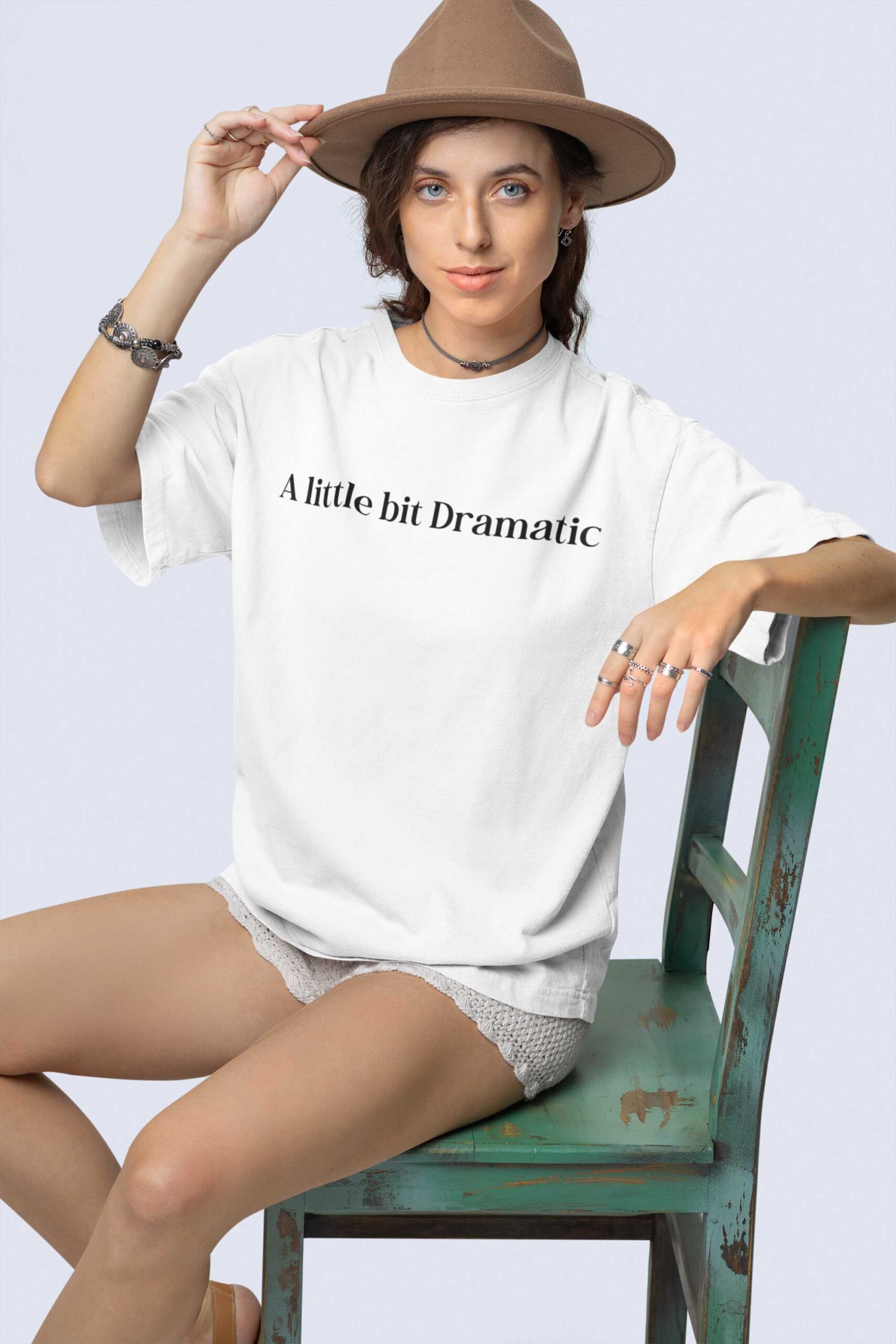 stanley-stella-t-shirt-mockup-featuring-a-woman-with-a-boho-styled-look-sitting-on-an-old-chair-m36870